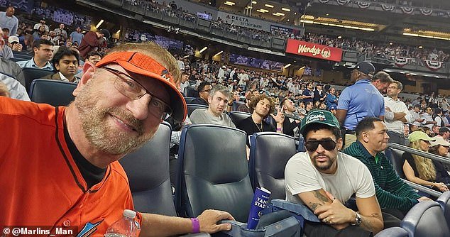 102904259-15183155-A_baseball_fan_sat_with_Bad_Bunny_at_a_Yankees_game_this_week_ha-a-4_176018664323.jpeg