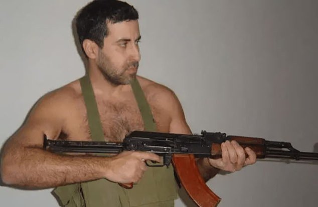 103109387-15205485-Dyab_Abou_Jahjah_pictured_brandishing_a_Kalashnikov_machine_gun_-a-40_17608291981.jpeg