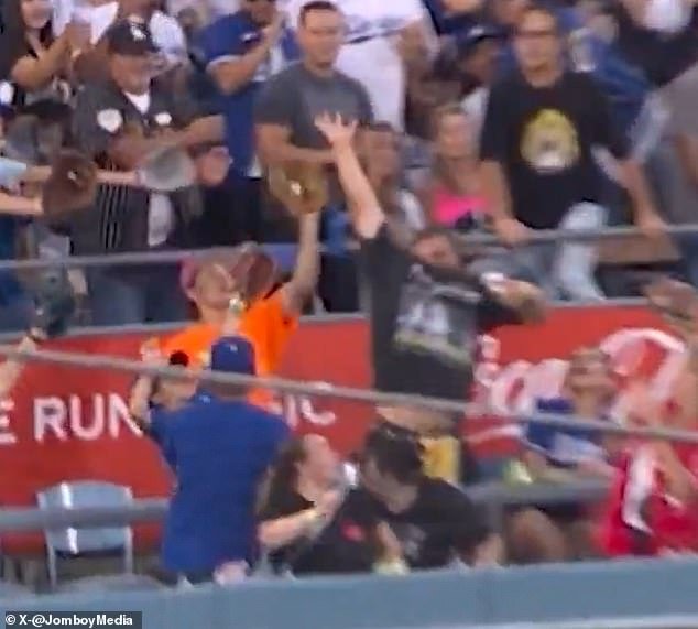 103450239-15241049-The_fan_in_the_orange_t_shirt_caught_Vlad_Guerrero_Jr_s_home_run-a-4_176184078684.jpeg