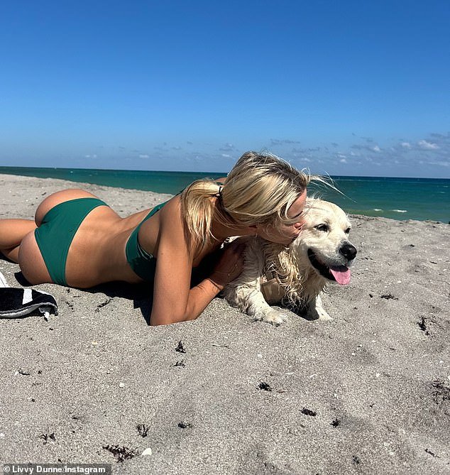 103913251-15294405-Livvy_Dunne_enjoyed_a_beach_day_with_her_dog_Roux_after_recently-a-20_17632436260.jpeg