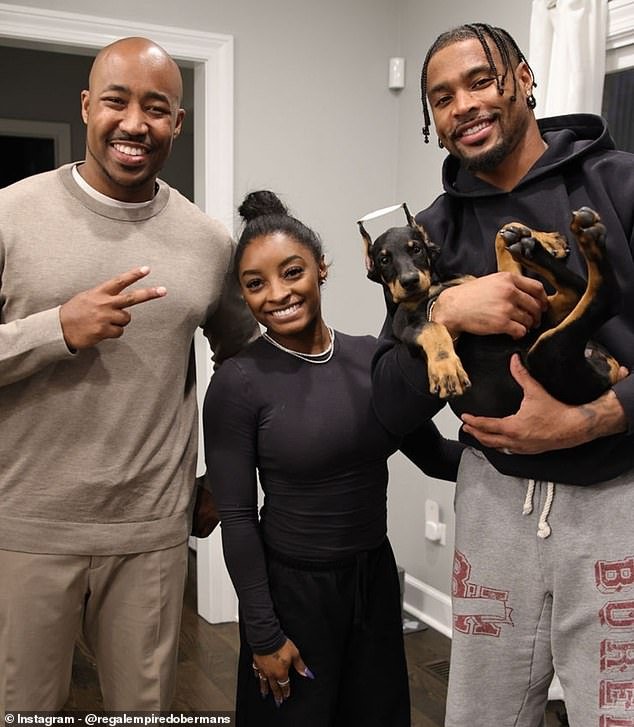 104831681-15394311-Simone_Biles_C_and_Jonathan_Owens_R_pose_with_the_breeder_and_th-a-50_17660262881.jpeg
