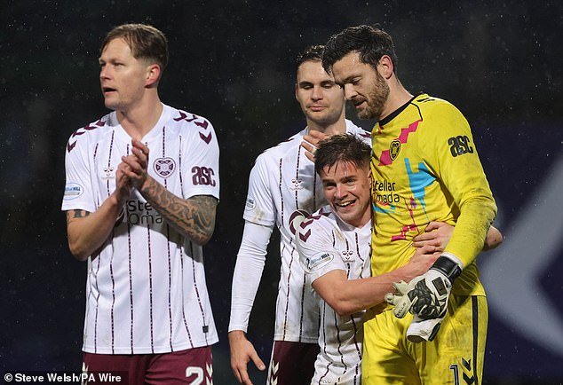 105422769-15454135-Hearts_goalkeeper_Craig_Gordon_is_congratulated_by_team_mates_af-a-41_17681621511.jpeg