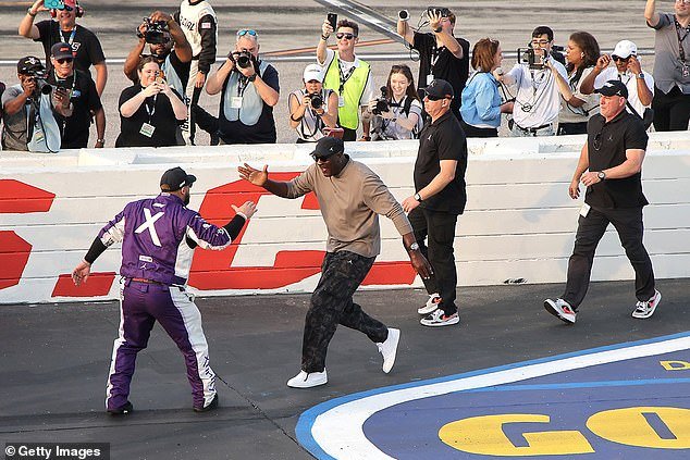 El máximo propietario de NASCAR, Michael Jordan, celebra la cuarta victoria del año del piloto Tyler Reddick en la fila de boxes.