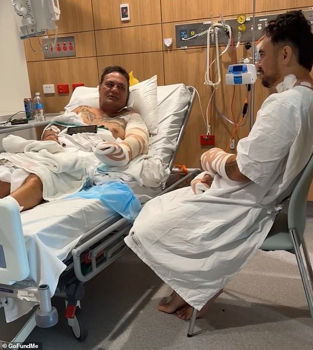 Un padre y un hijo quedaron luchando por sus vidas después de que supuestamente fueron apuñalados en su propio patio trasero en una horrible disputa vecinal.